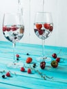 Refreshing cocktail with vodka martini with ice and berries on wood table Royalty Free Stock Photo