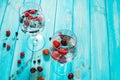 Refreshing cocktail with vodka martini with ice and berries on wood table Royalty Free Stock Photo