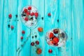 Refreshing cocktail with vodka martini with ice and berries on wood table Royalty Free Stock Photo