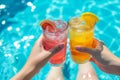 refreshing cocktails in the pool. Colorful iced cocktails garnished with lime and orange slices. bright sunny day. Rest and