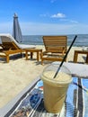 refreshing coffee drink on the beach against the backdrop of sun loungers, umbrellas Royalty Free Stock Photo