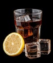 Refreshing cola drink with ice cubes and lemon slice