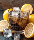 Refreshing cola drink with lemon and ice cubes
