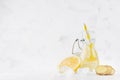 Refreshing cold fruit drink with citrus lemon, bright bubbles, ice, ginger and straw in transparent yoke bottle in elegant white. Royalty Free Stock Photo