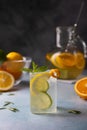 Refreshing cold summer drink with orange, lemon, lime, mint and rosemary. A misted glass with ice and citrus slices. Royalty Free Stock Photo