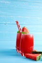 Refreshing cold watermelon juice smoothie drinks for summer in the glass on blue wooden table background Royalty Free Stock Photo