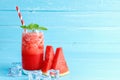 Refreshing colorful watermelon juice with mint on blue old wooden the table background with copy space