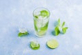 Refreshing cool detox drink with lime and mint on blue background. Summer lemonade or ice tea in a glass. Mojito cocktail with ice Royalty Free Stock Photo