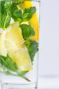 Refreshing detox infused sassy water with lemon fresh mint ginger in glass on white table. Healthy natural belly anti-bloating Royalty Free Stock Photo