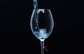 Refreshing drink concept. Cocktail with blue liquid in glass. Glass with blue water pouring with liquid with splashes Royalty Free Stock Photo