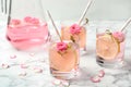 Refreshing drink with lemon and rose on marble table