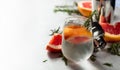 Gin and tonic cocktail with natural ice, grapefruit, and rosemary in a frozen glass Royalty Free Stock Photo