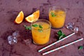 Refreshing drink, orange cocktail with basil in glasses Royalty Free Stock Photo