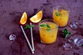 Refreshing drink, orange cocktail with basil in glasses Royalty Free Stock Photo