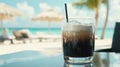 A refreshing drink rests on a table at the beach, inviting relaxation and enjoyment under the sun. Royalty Free Stock Photo