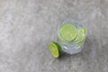 Refreshing drink, water with ice and lime on a gray background.Fresh,heathy and colorful.