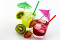 Refreshing drinks with a straw, umbrella and fruit