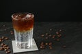 Refreshing espresso tonic drink and coffee beans on dark table. Space for text Royalty Free Stock Photo