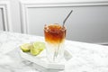 Refreshing espresso tonic drink and lime on white marble table Royalty Free Stock Photo