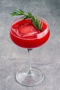 A refreshing fruit cocktail. A refreshing drink with a pulp of red berries, decorated with rosemary Royalty Free Stock Photo