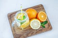 Refreshing fruit cocktail with lemon, orange and mint. Glass jar