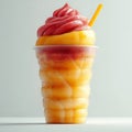 A refreshing fruit dessert in a plastic cup with a straw and a swirl of pink topping on top Royalty Free Stock Photo