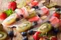 refreshing fruit popsicle lollies with berries, fruits peppermint on wooden background. horizontal