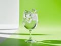 Refreshing gin tonic in a glass with ice on green background. Royalty Free Stock Photo