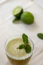 Refreshing glass of beverage with green lime on the table for garnish Royalty Free Stock Photo