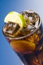 Refreshing glass of cola with lemon and ice