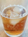 A Refreshing Glass of Iced Lemon Tea Resting on a Wooden Table, CafÃ© in Bangkok.