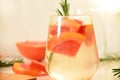 Refreshing grapefruit cocktail with ice and rosemary on a white background. rosemary on the table. or detox water or Royalty Free Stock Photo