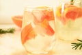 Refreshing grapefruit cocktail with ice and rosemary on a white background. rosemary on the table. or detox water or Royalty Free Stock Photo