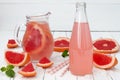 Refreshing grapefruit cocktail with mint over old vintage wooden table.