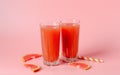 Refreshing grapefruit juice with straws on a pink background with grapefruit slices. Summer refreshing diet drink Royalty Free Stock Photo