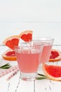 Refreshing grapefruit and rosemary cocktail over old vintage wooden table.