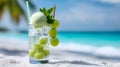 Refreshing green grape cocktail on tropical beach with ocean view Royalty Free Stock Photo