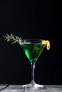 Refreshing green martini cocktail in a martini glass on the black background Royalty Free Stock Photo