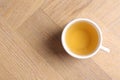 Refreshing green tea in cup on wooden table, top view. Space for text Royalty Free Stock Photo