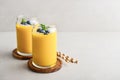 Refreshing and healthy mango smoothie with coconut flakes and fresh blueberries Royalty Free Stock Photo