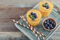 Refreshing and healthy mango smoothie in glasses with coconut flakes and fresh blueberries Royalty Free Stock Photo