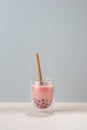 Refreshing homemade iced milky bubble tea with tapioca pearls. Strawberry and raspberry bubble tea on spring background Royalty Free Stock Photo