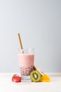 Refreshing homemade iced milky bubble tea with tapioca pearls. Strawberry and raspberry bubble tea on spring background Royalty Free Stock Photo