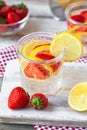 Refreshing homemade lemonade with fresh strawberry, lemon and ice. Healthy cold drink, low calories. Tasty cool summer beverage.