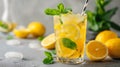 Refreshing homemade lemonade with lemon slices and mint in a tall glass on a gray concrete background Royalty Free Stock Photo