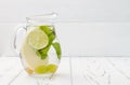 Refreshing homemade lime and mint cocktail over old vintage wooden table. Detox fruit infused flavored water. Clean eating Royalty Free Stock Photo