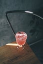 Refreshing homemade pink lemonade on wooden chair with light and shadow.Glass pitcher of sparkling soft drink with juice,soda and Royalty Free Stock Photo