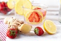 Refreshing homemade sparkling lemonade with fresh strawberry, lemon, ice and ginger. Healthy cold drink, low calories. Tasty cool Royalty Free Stock Photo