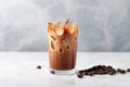 Refreshing iced coffee with milk and beans on marble table, morning drink concept