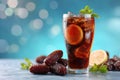 Refreshing iced lemon cola with dates and mint garnish on a bright blue Royalty Free Stock Photo